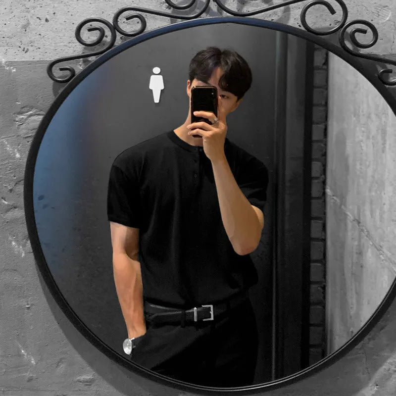 Man wearing a thin black short-sleeved knitted slim-fit pullover shirt.