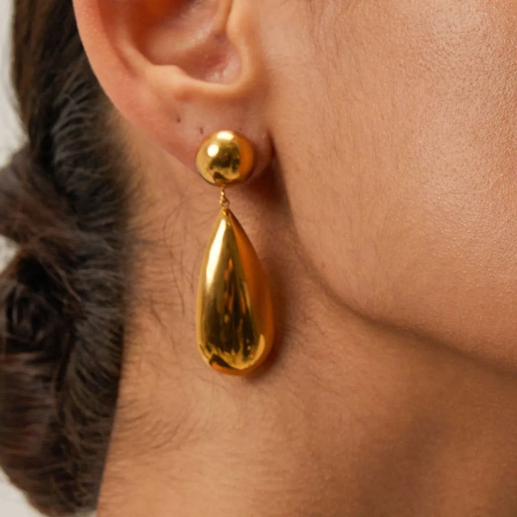 Gold geometric hemisphere water drop pendant earrings made from stainless steel.