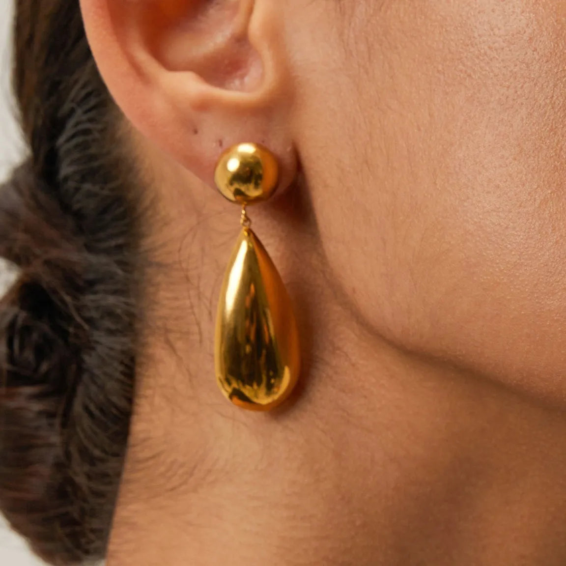 Gold geometric hemisphere water drop pendant earrings made from stainless steel.