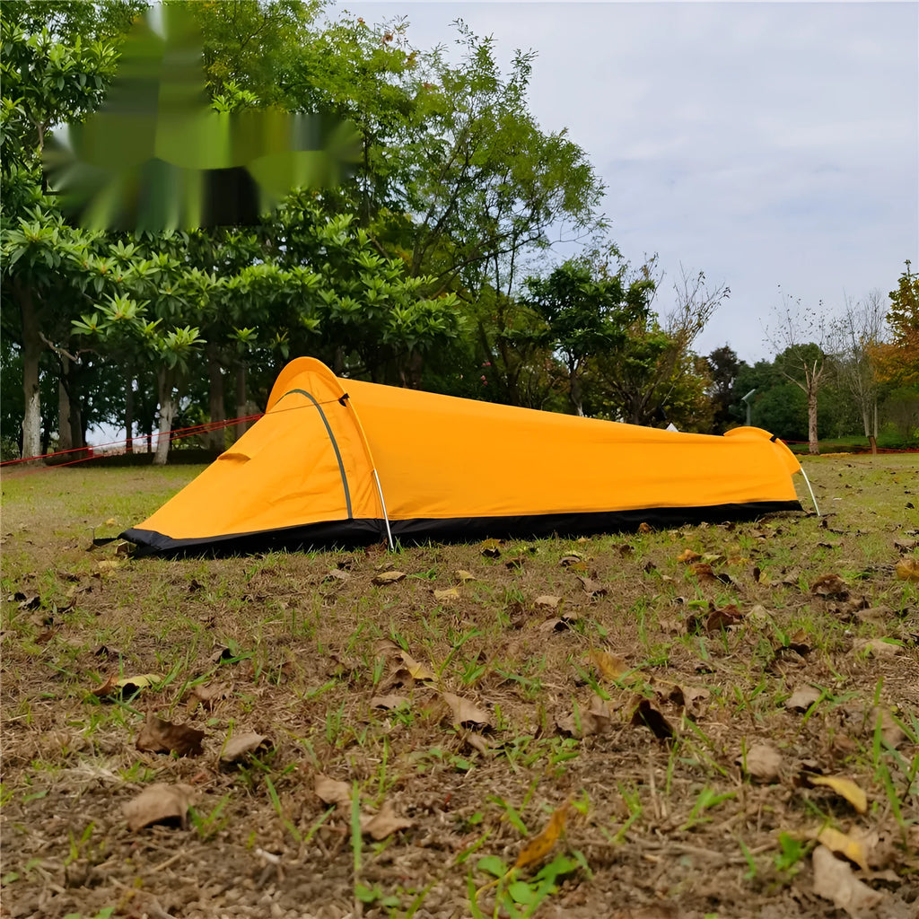 Single person sleeping bag tent in army green set up outdoors, showing rain fly and aluminium rod poles.