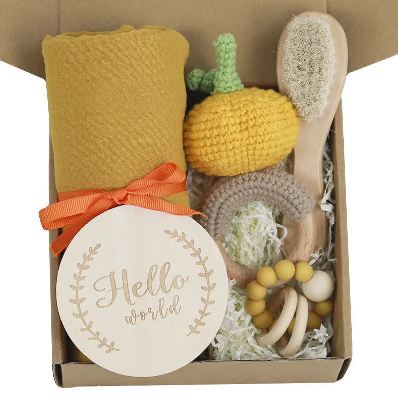 Baby teething gift set with bamboo gauze blanket, wooden chewing ring, woven bell, and developmental toys