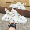 Men's low-top casual sneaker in grey with mesh upper, thick rubber sole, and round toe.