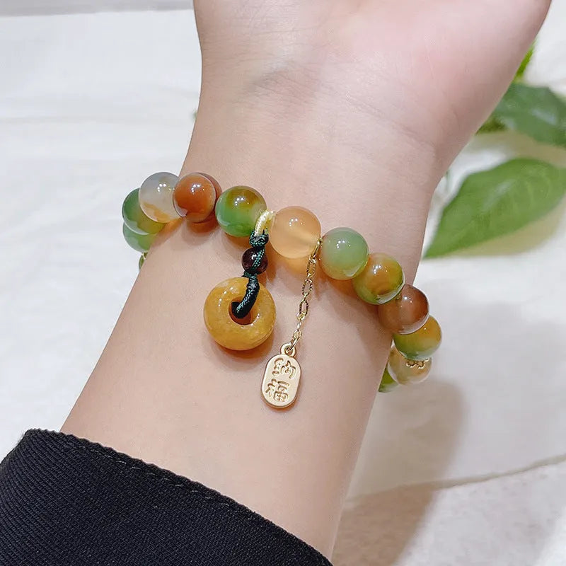 Women's peacock agate and topaz bracelet with a traditional peace buckle clasp.