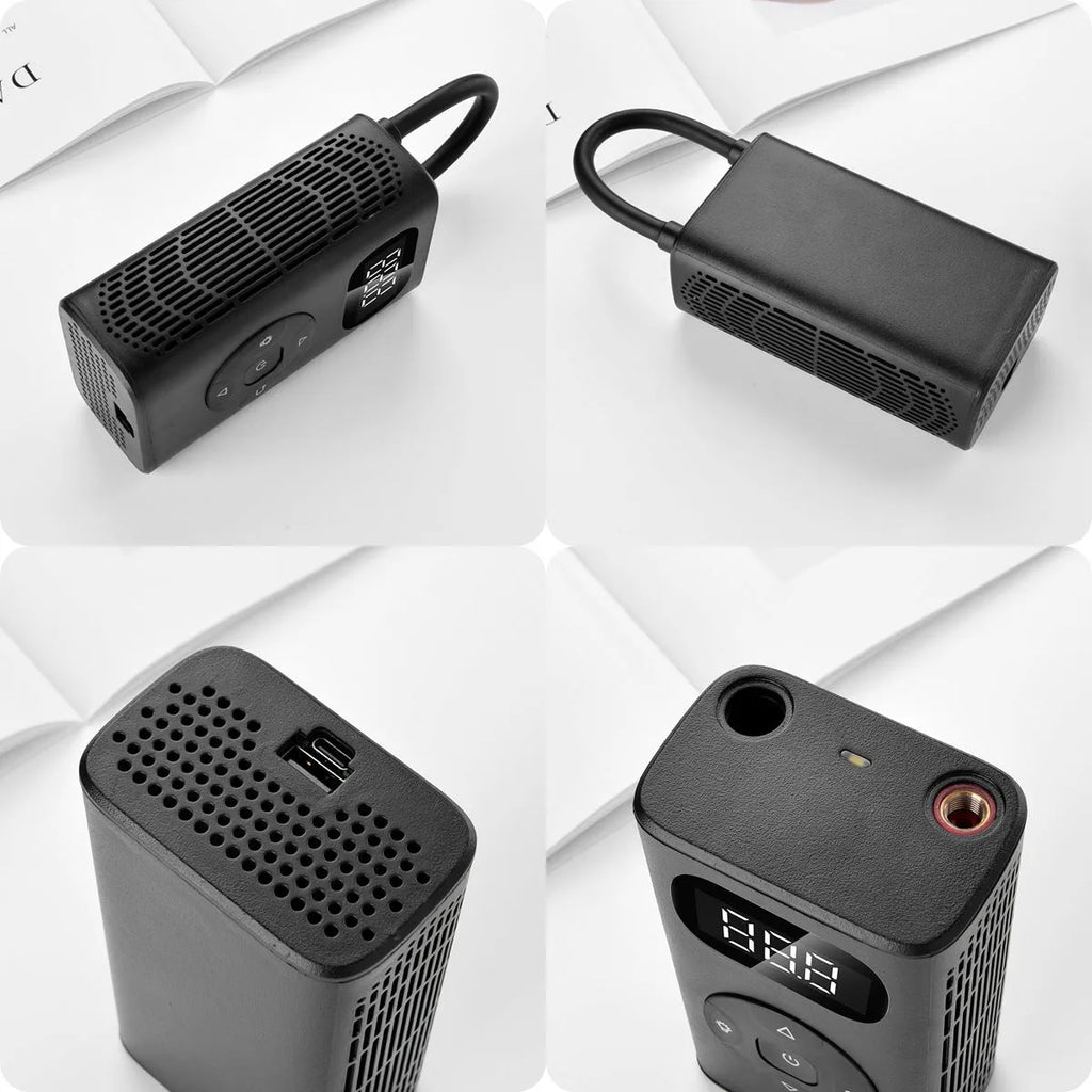 Black portable power bank tyre inflator with USB cable on a grey background.