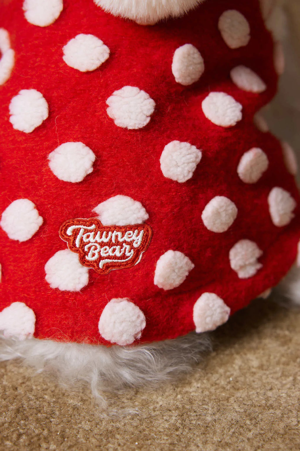 Red polka dot sleeveless hooded dog vest coat on a pet, front view, polyester fabric