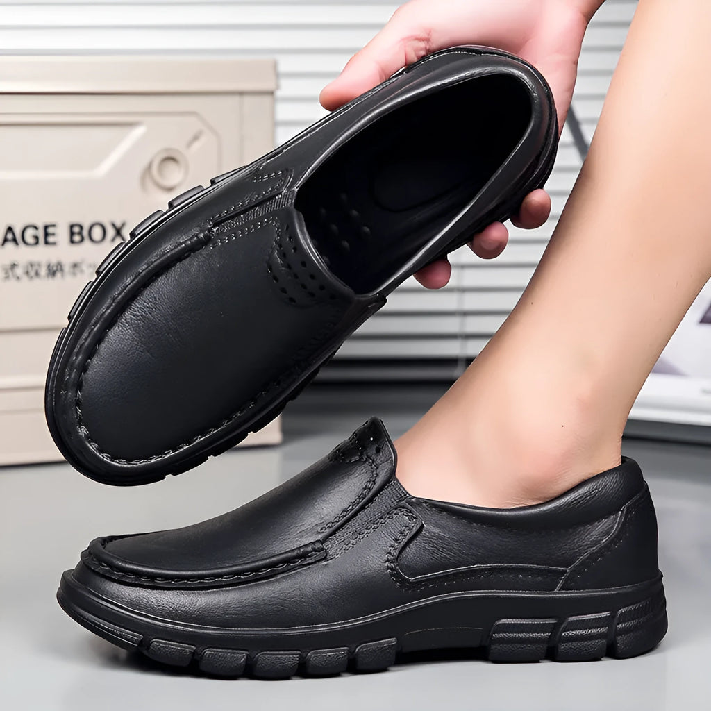 Men's black slip-on work shoes with a platform sole and round toe.