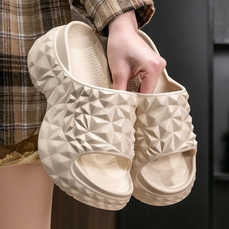 A pair of khaki high heel flip flop slippers made from injection moulded EVA with a thick sole.