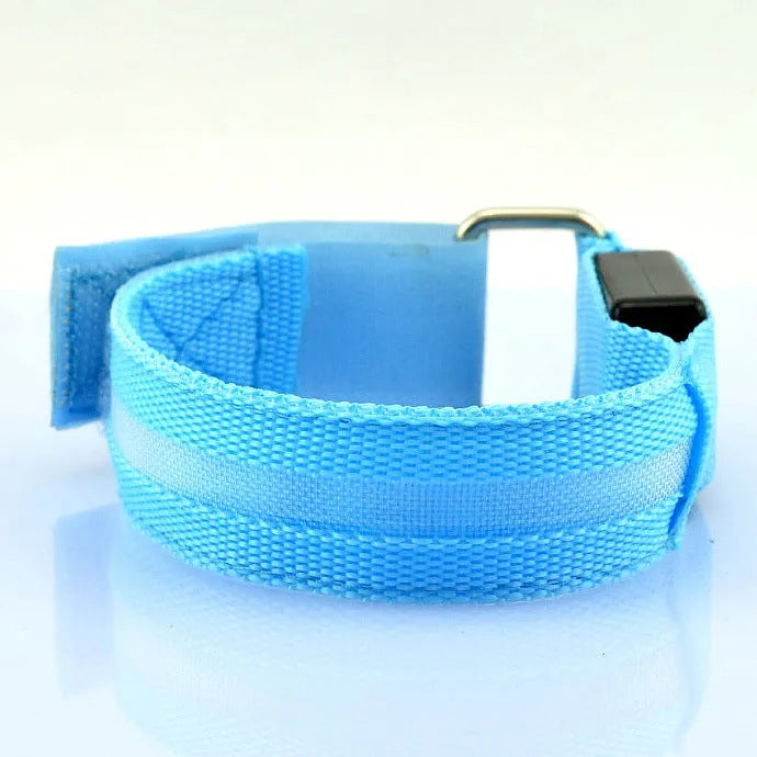 Illuminated arm band with LED lights on a black ribbon, adjustable, showing blue and red colours