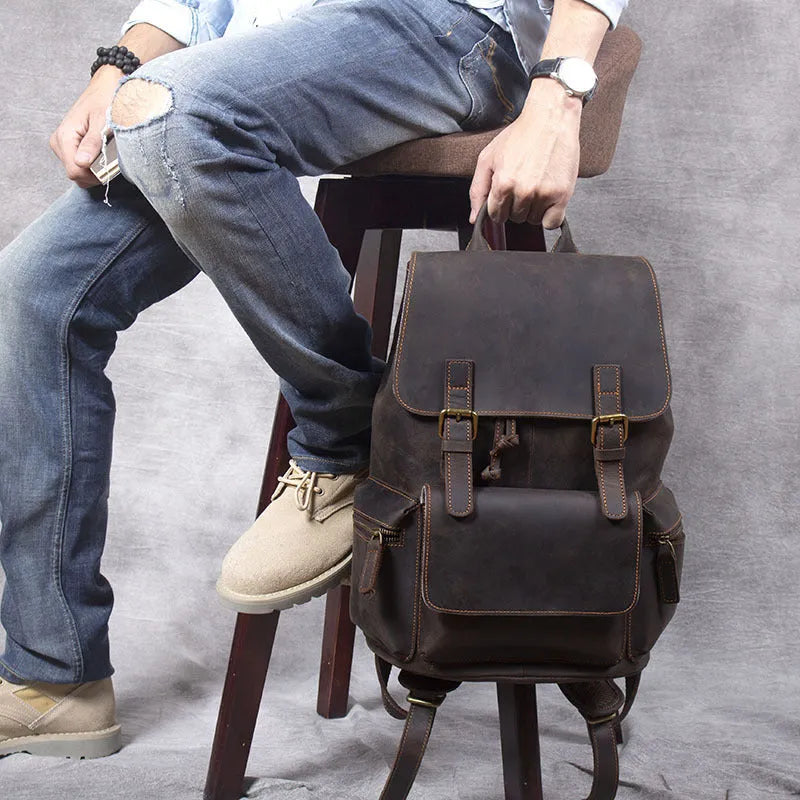 Brown retro-style leather backpack with shoulder straps, made from first layer cowhide with denim lining.