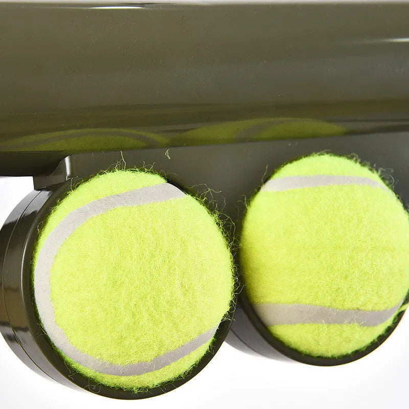 Black tennis ball launcher for dogs with two tennis balls, measuring 65.5cm long