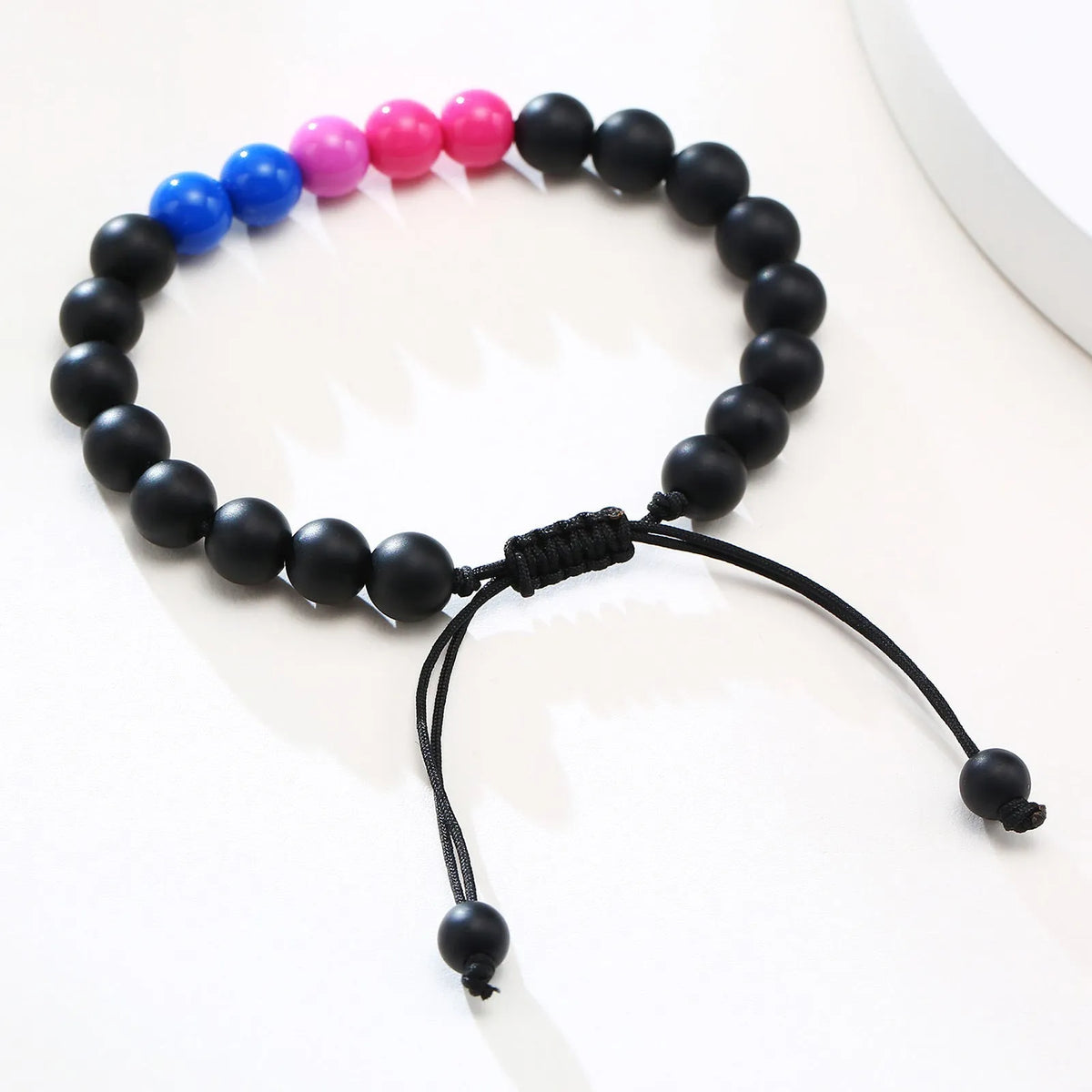 Polished black agate beaded bracelet with 8mm beads, unisex style, on a neutral background.