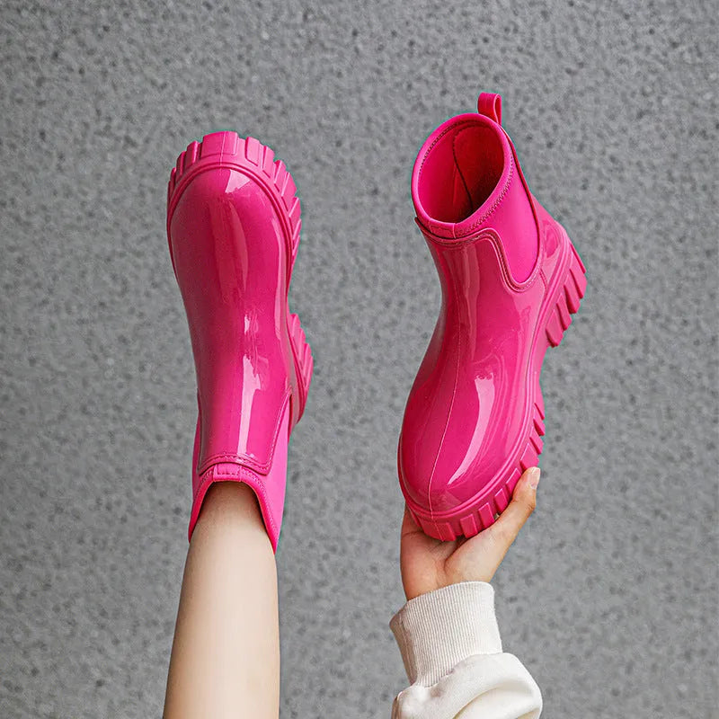 Creamy-white low tube PVC rain boots with a flat heel and non-slip sole on a plain background.