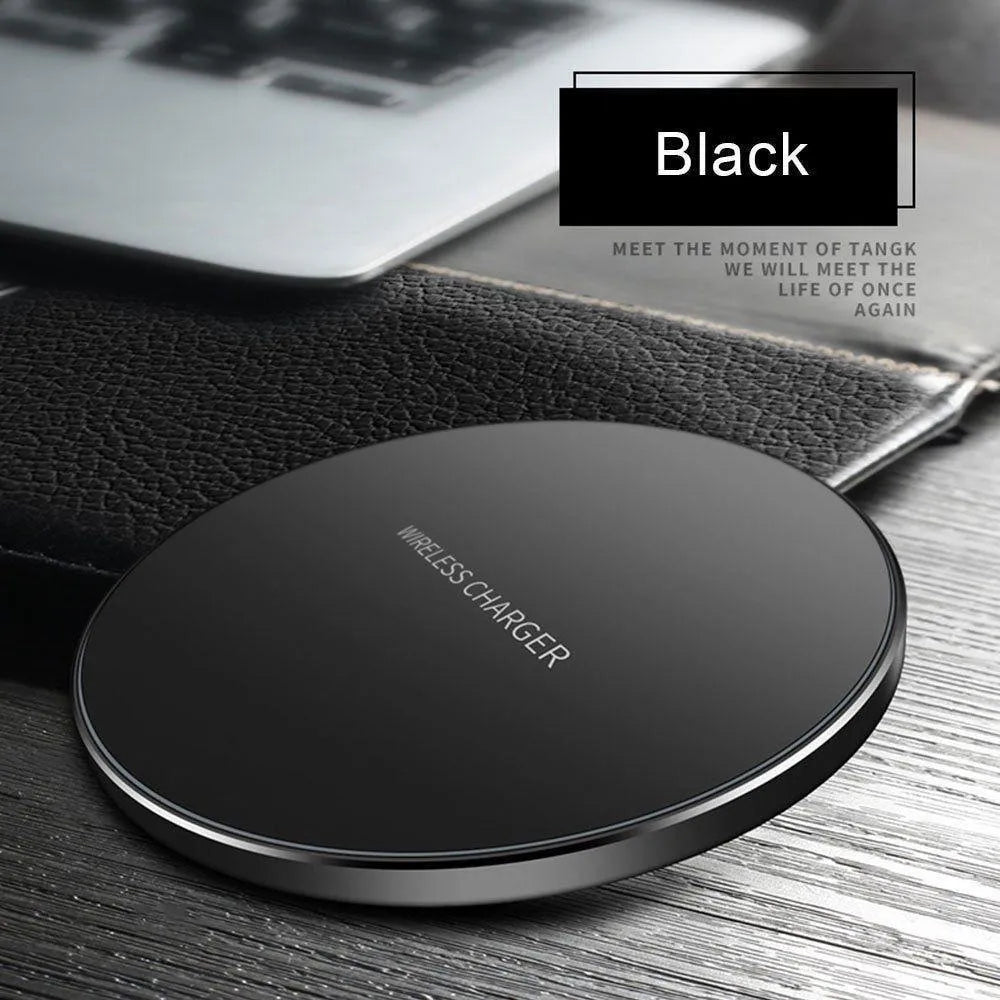 Black square wireless charging pad on desk with smartphone charging wirelessly