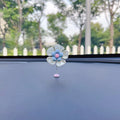 Small colourful plastic swing ornament for car dashboard, shown in multiple colour options.