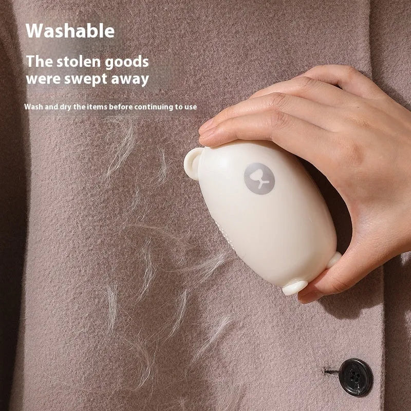 Washable reusable lint roller in white, pink, or green for removing lint from clothes and furniture.