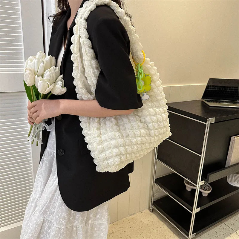 Women's soft pleated bubble shoulder bag in a vertical square shape with a pendant, shown in one of five colour options.