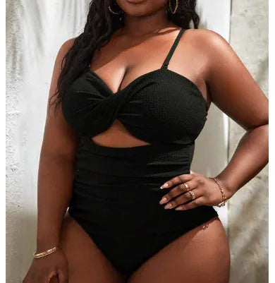 Black solid colour plus size one-piece swimsuit for women on a mannequin.
