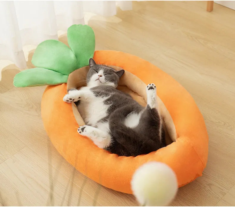 Orange carrot-shaped dog nesting bed with a raised bolster edge and a separate soft blanket, shown in two sizes.