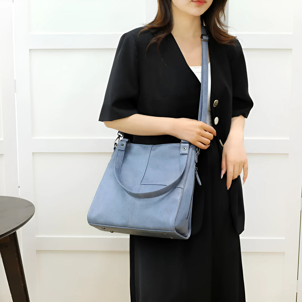 Soft PU leather crossbody handbag with barrel shape and vintage styling in light khaki colour