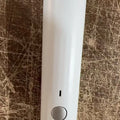 USB electric vacuum sealer pump with reusable food storage envelope bags on a kitchen counter