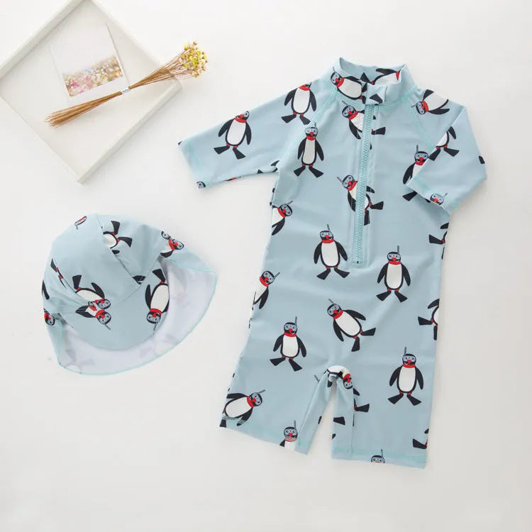 Boy's penguin print long sleeve swim shirt and matching cap set for sun protection.