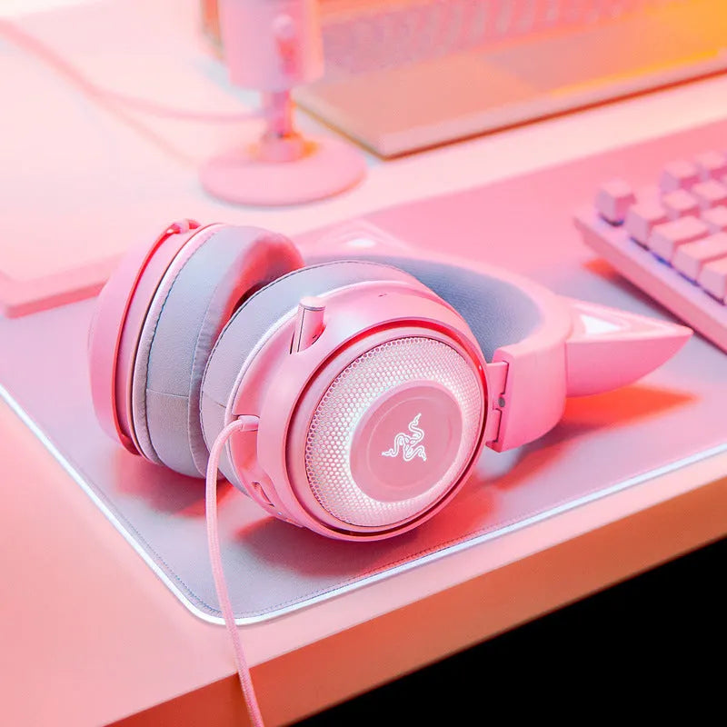Pink glowing cat earphones wired USB headphones with LED cat ear lights on a plain background