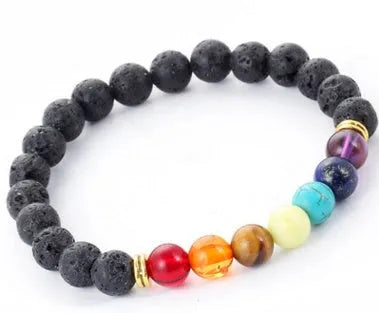 Handmade black lava seven chakra beaded bracelet on neutral background, 8mm or 10mm beads