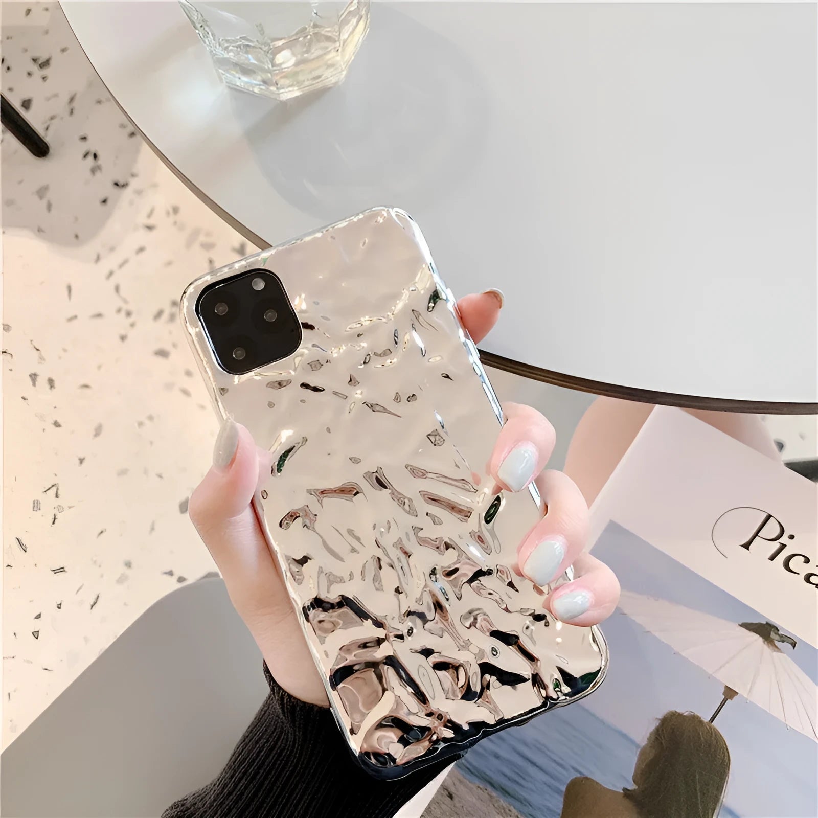 Rose gold and silver coloured TPU back cover cases for iPhone on a plain background.