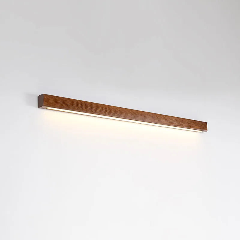 Modern wooden log strip wall lamp mounted on a wall in walnut colour