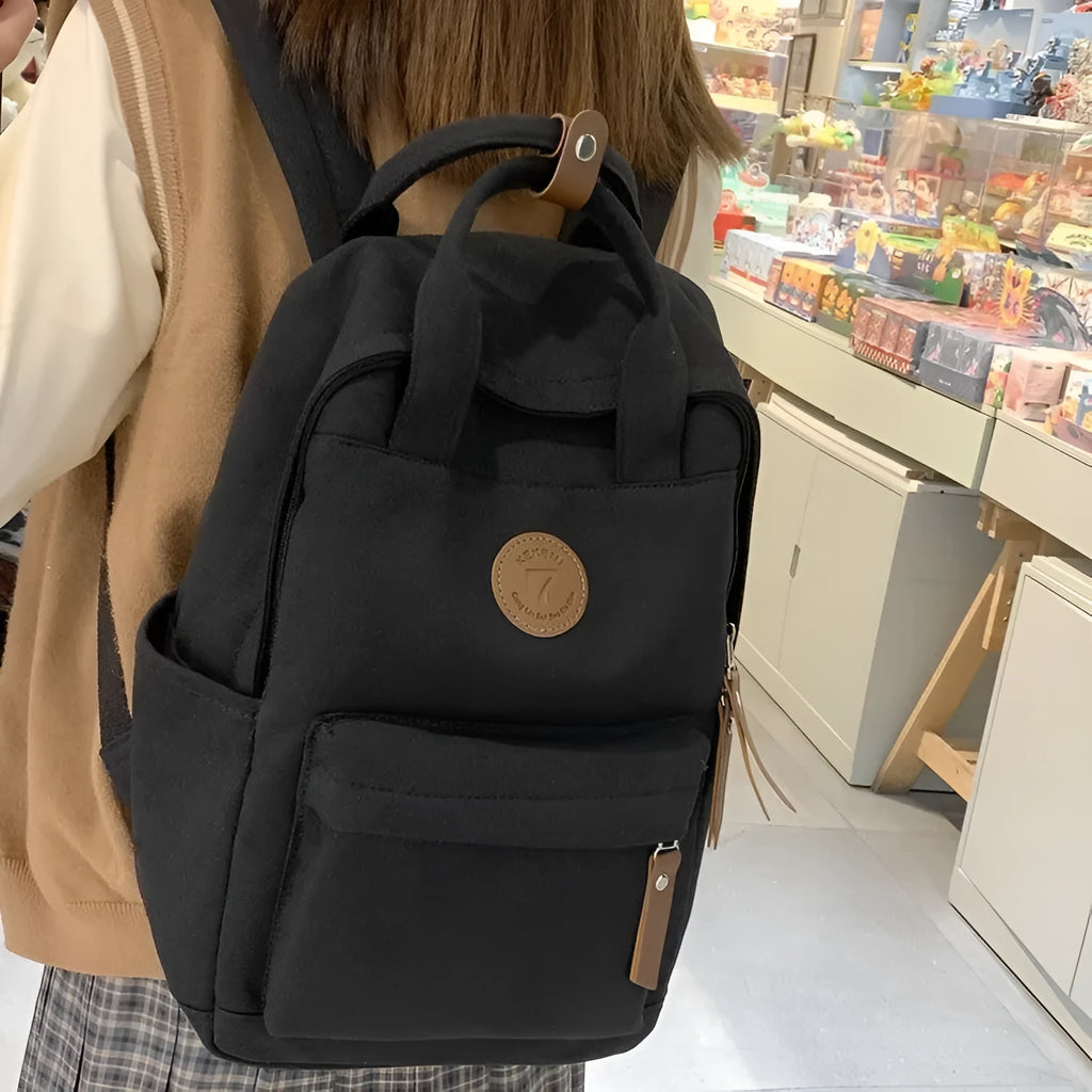 Black Oxford cloth fashion backpack with curved shoulder straps for burden reduction