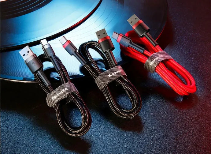 Grey and black woven nylon Android micro USB charging cable shown coiled with connector visible
