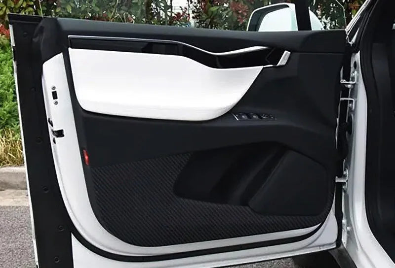 Four pre-cut carbon fibre protective films for Tesla Model S interior door control layouts.