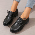 Black women's work shoes with a chunky heel, round toe, and low top design on a rubber sole.