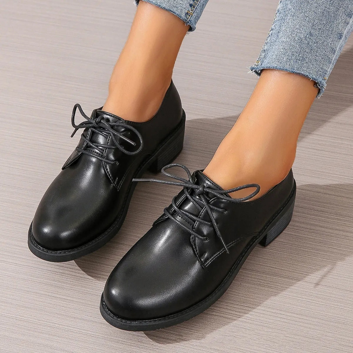 Black women's work shoes with a chunky heel, round toe, and low top design on a rubber sole.