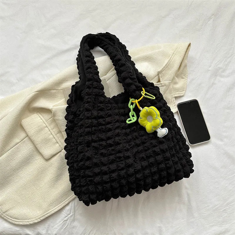 Women's soft pleated bubble shoulder bag in a vertical square shape with a pendant, shown in one of five colour options.