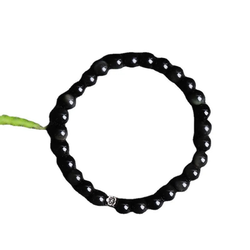 Natural black obsidian bracelet with S925 sterling silver flower charm and dragon phoenix decorations on wrist