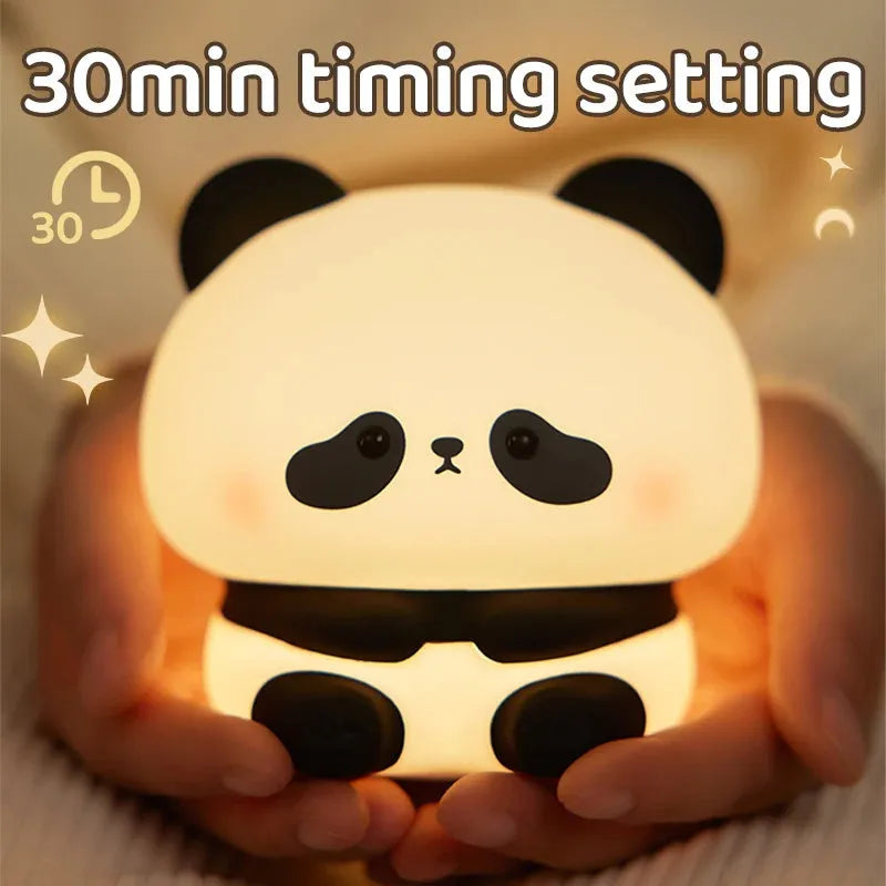 Cute panda LED night light with soft silicone cover, USB rechargeable, featuring colourful lighting modes on a bedside table.