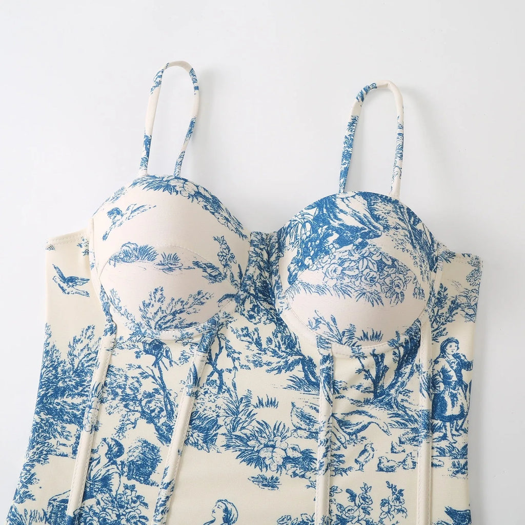 Blue patterned one-piece swimsuit for women on a mannequin, with an optional gauze skirt shown alongside.