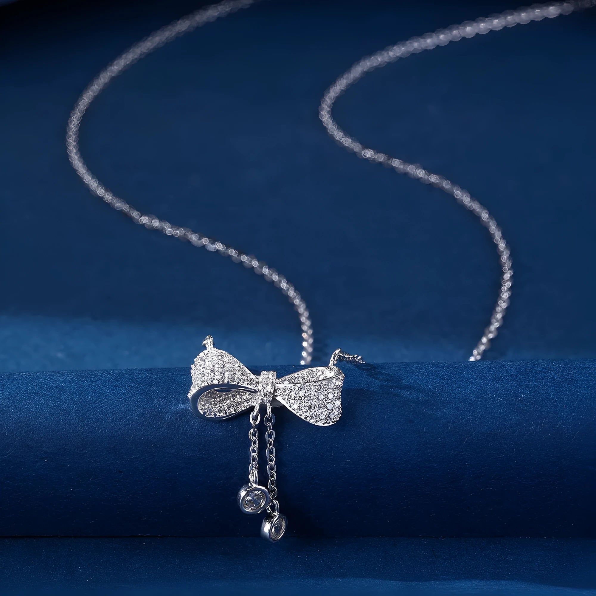 S925 sterling silver bow necklace on collarbone, showing O-ring chain and detailed bow pendant