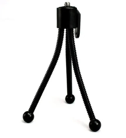 Silver iron mini desktop tripod with folded legs and a black universal ball head mount.