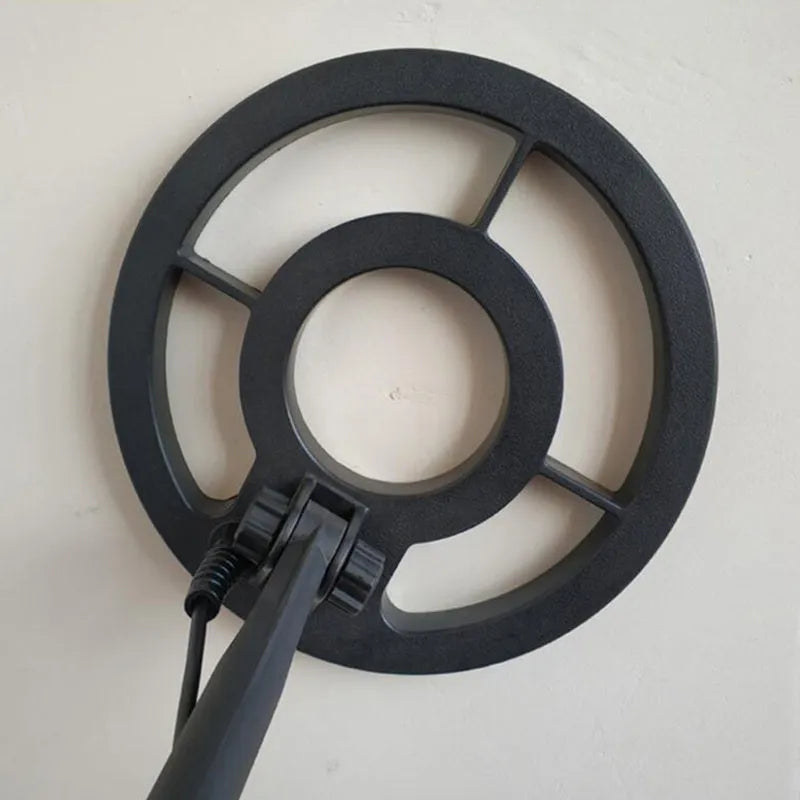 GC1028 black and yellow metal detector with LCD screen and adjustable shaft on grass.