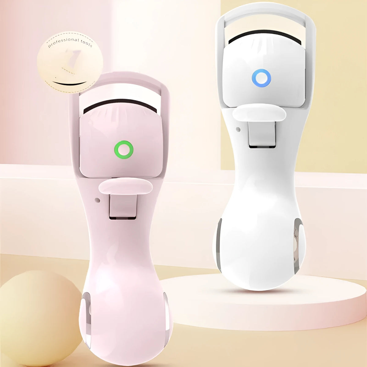 Electric eyelash curler in pink or white with silicone pad, USB cable, and three-speed temperature control.
