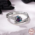 Adjustable silver skull hand ring with heart shaped base and pumpkin skull detail on white background