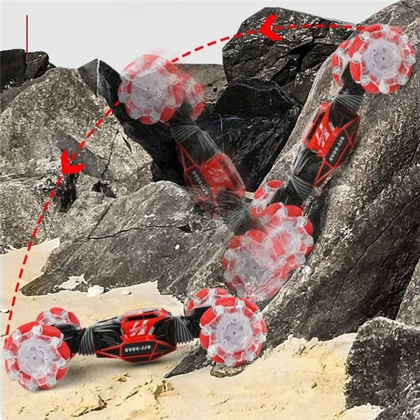 Red remote control stunt car with gesture control, morphing off-road tyres, lights, and music, measuring 32 cm long