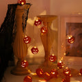LED Halloween string lights with pumpkin-shaped iron pendants in warm white, 1.65m length with 10 lights displayed on a dark background