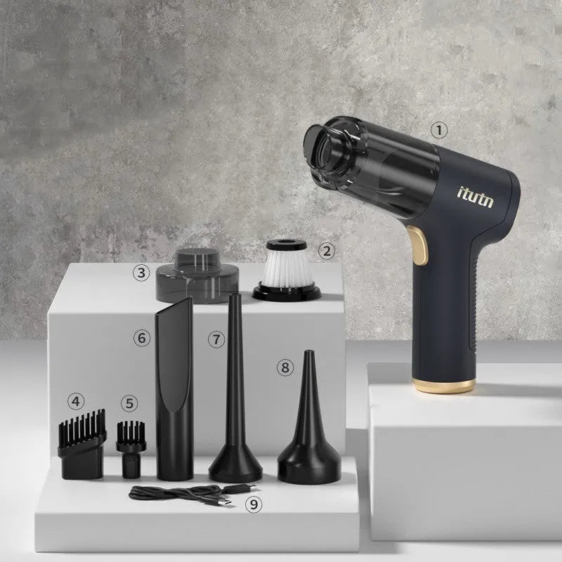 Black wireless handheld car vacuum cleaner with assorted nozzles and a USB cable