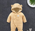 Baby wearing a cosy white cotton padded lamb-themed winter bodysuit with long sleeves.