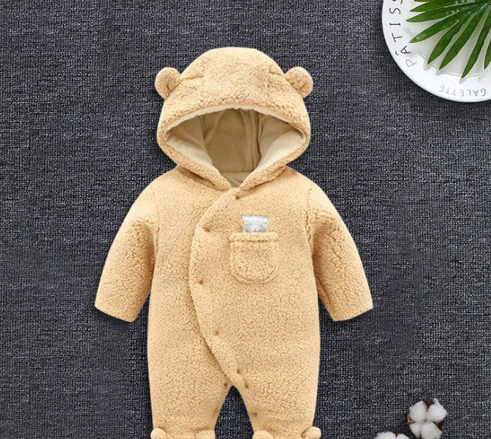 Baby wearing a cosy white cotton padded lamb-themed winter bodysuit with long sleeves.