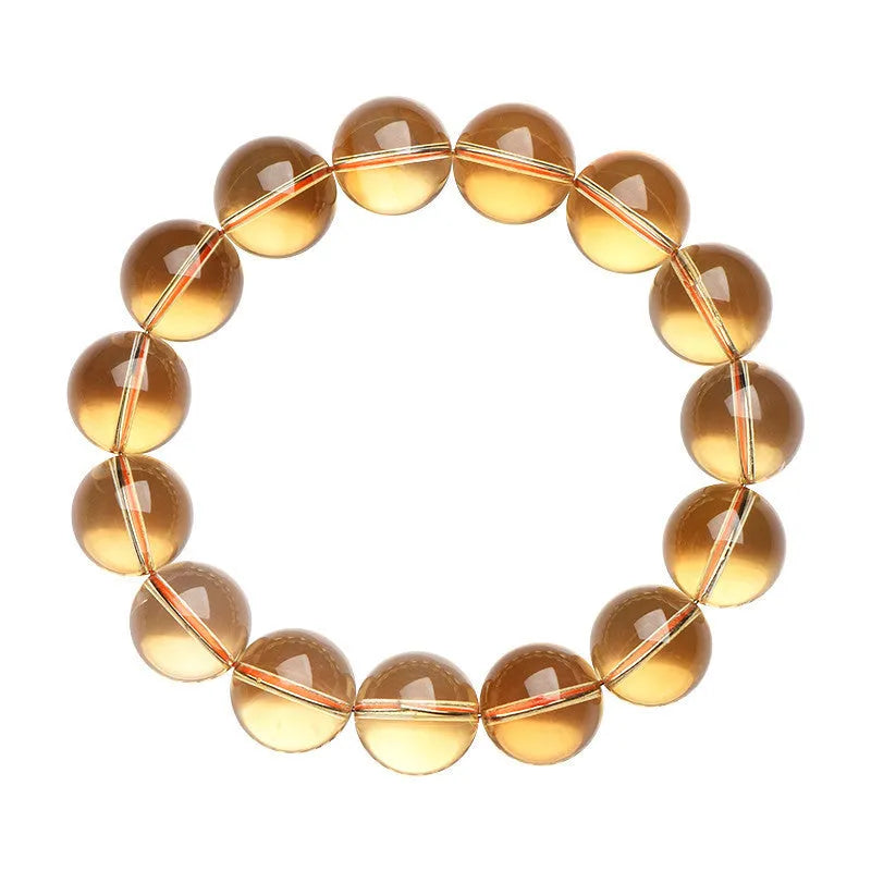 Original design bracelet with scattered, polished natural citrine beads in golden yellow tones on a wrist.