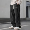 Men's straight leg corduroy trousers in khaki, drawstring waist, mid rise, polyester fabric, side view on model